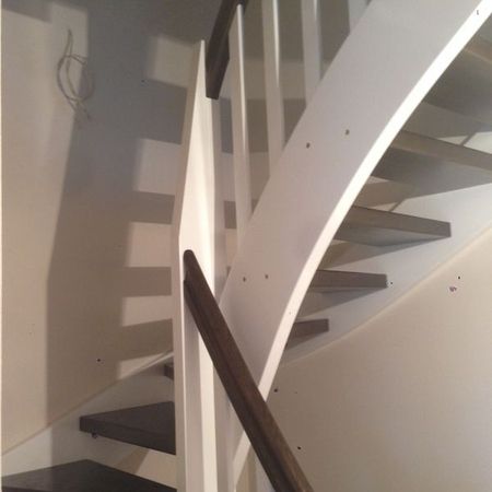 Weiße Holztreppe mit braunem Handlauf