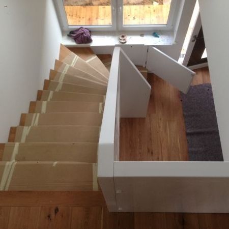 Holztreppe mit geschlossenem Geländer in weiß